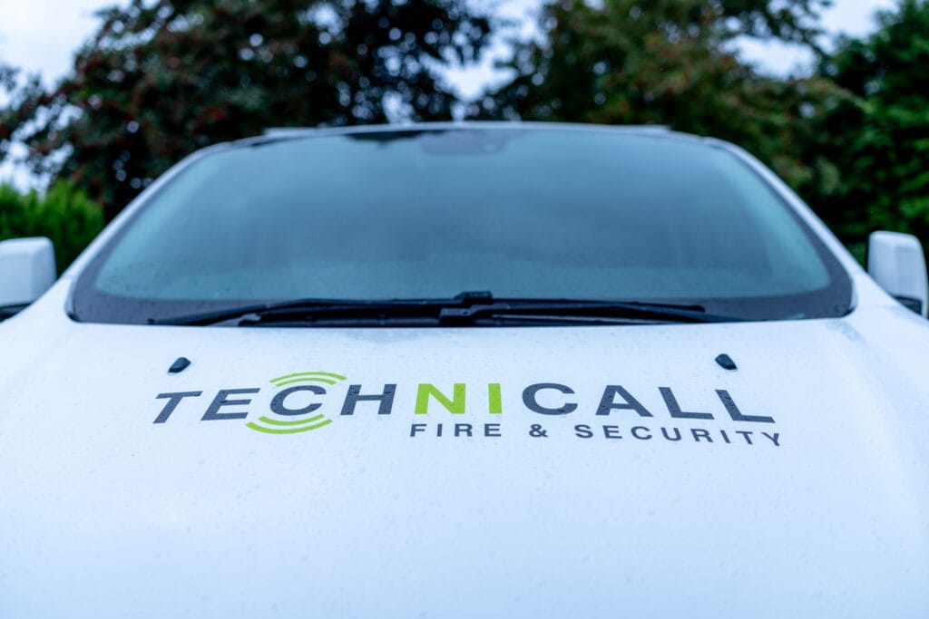 White Technicall Fire & Security van bonnet with green and grey logo close-up
